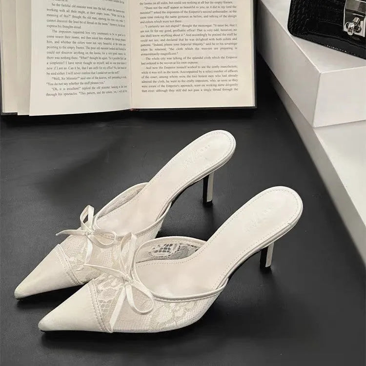 Women's light brown lace bowknot pointed toe high heels with mesh upper on a neutral background.