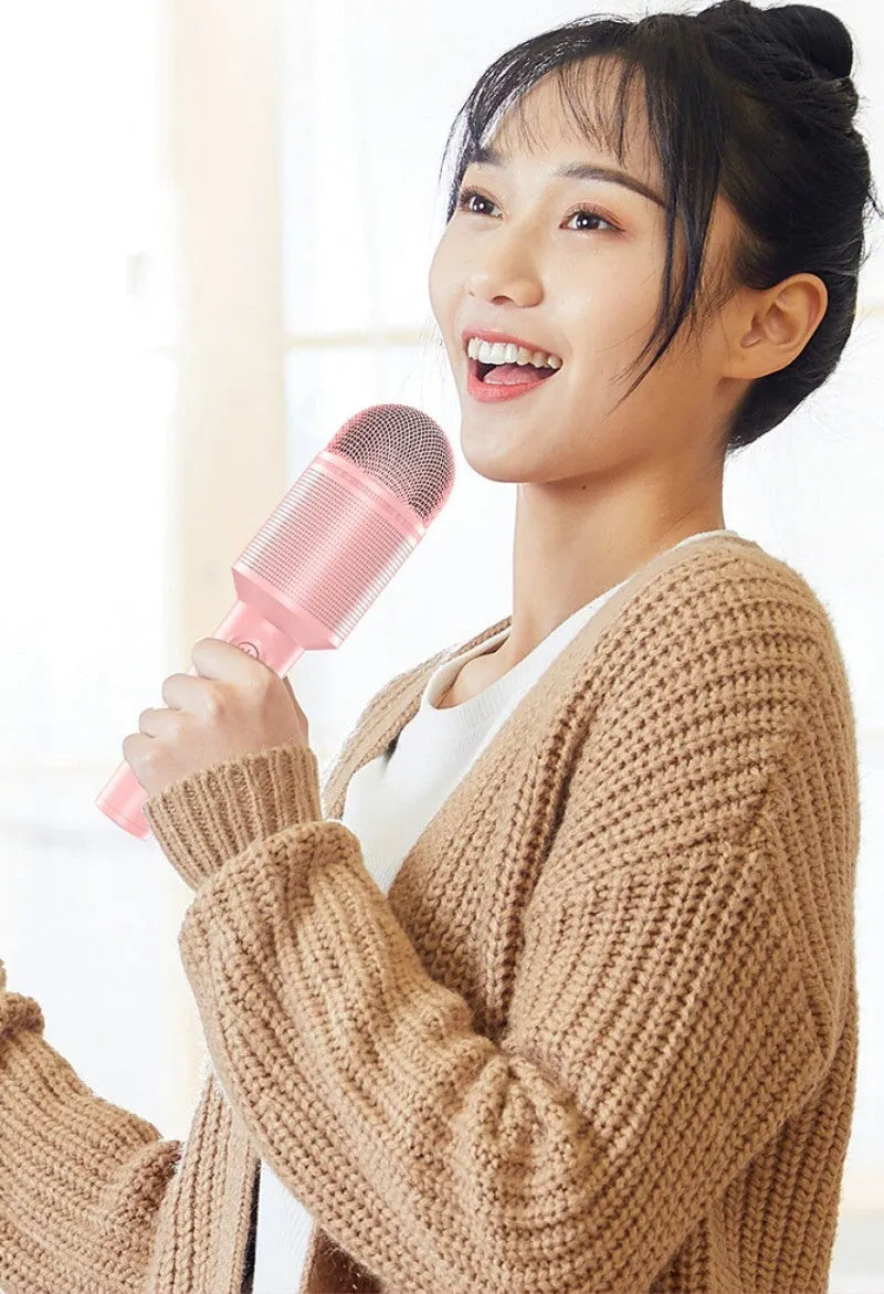Wireless Bluetooth karaoke microphone with integrated speaker in blue, pink, or green colour options.