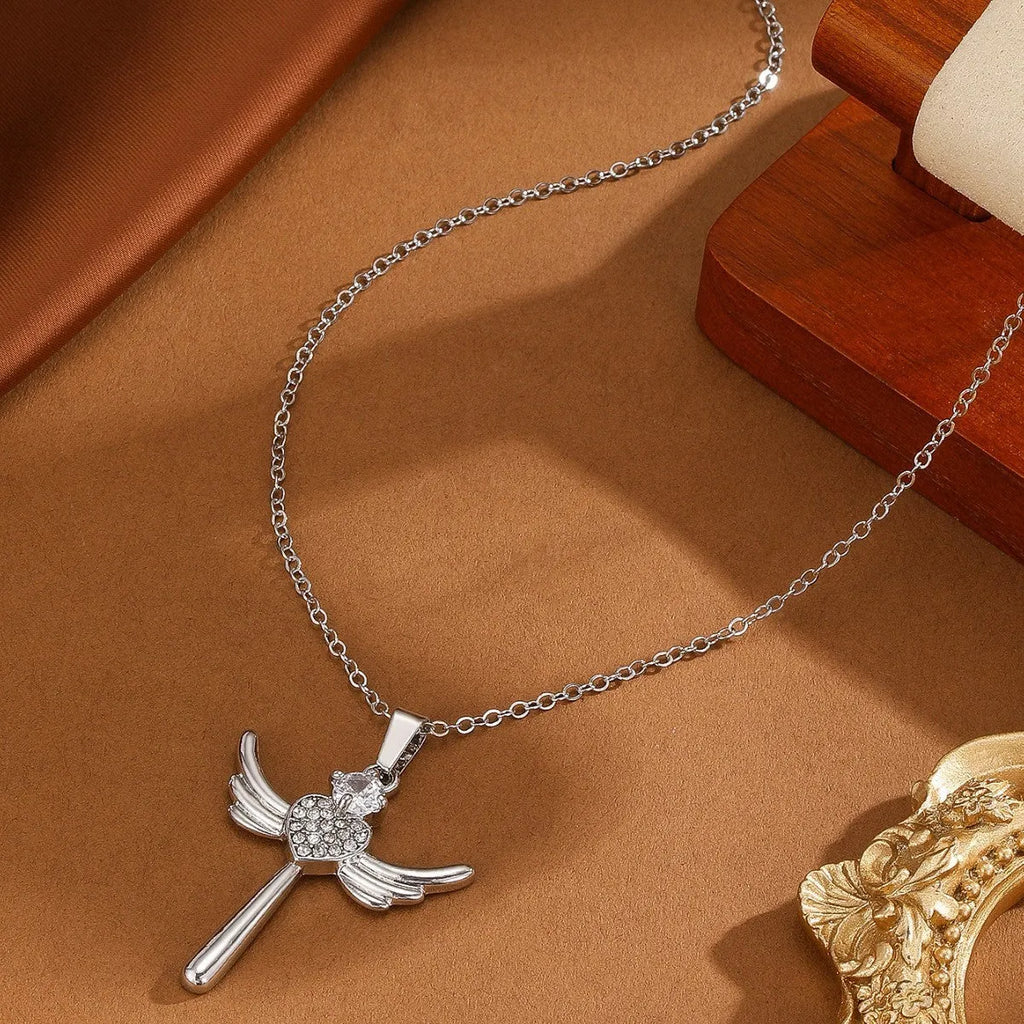 Silver heart-shaped angel wings pendant clavicle chain necklace with cross elements on display