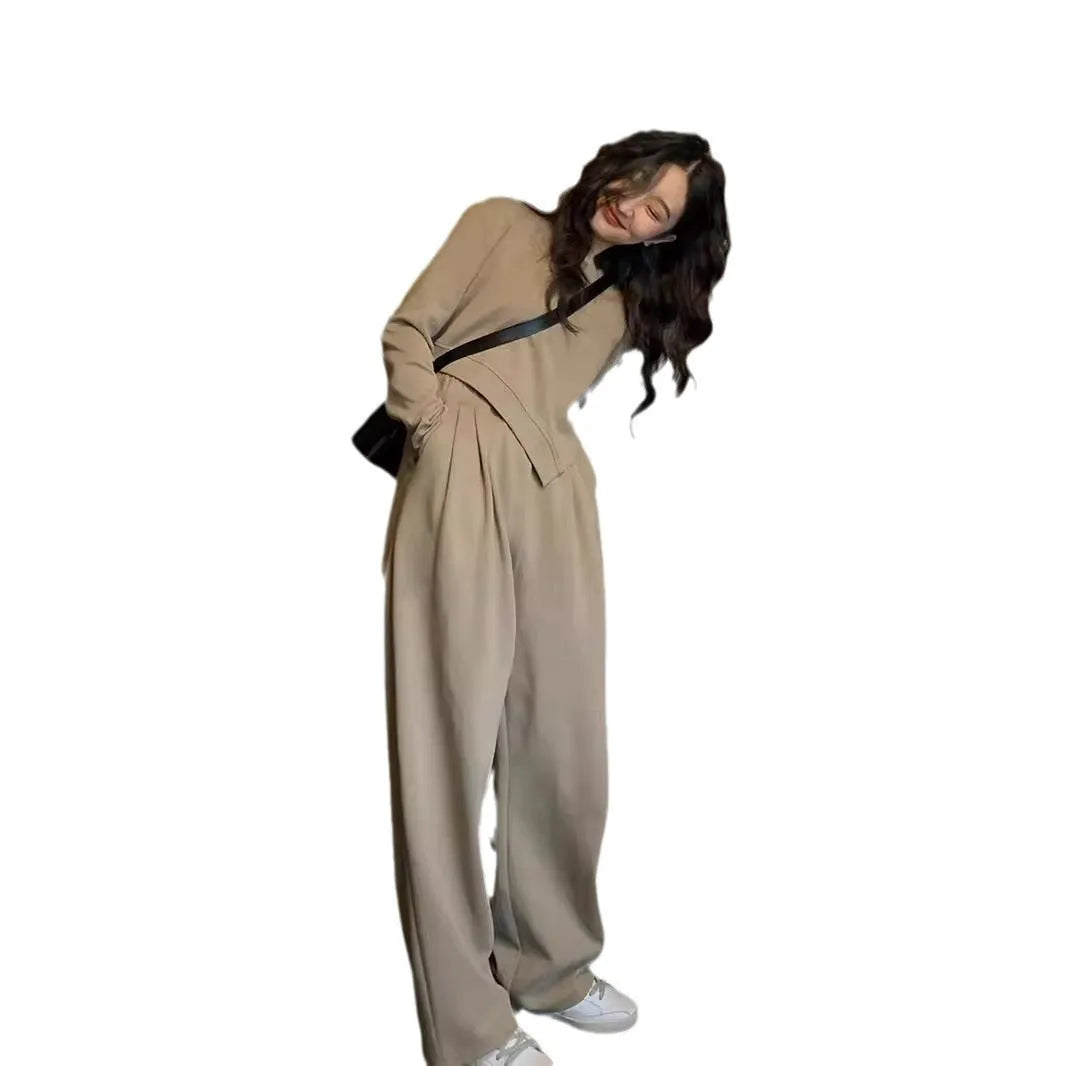Women's loose brown polyester sports suit with top and trousers on a hanger.