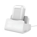 White headphone charging base with minimalist design on desk surface
