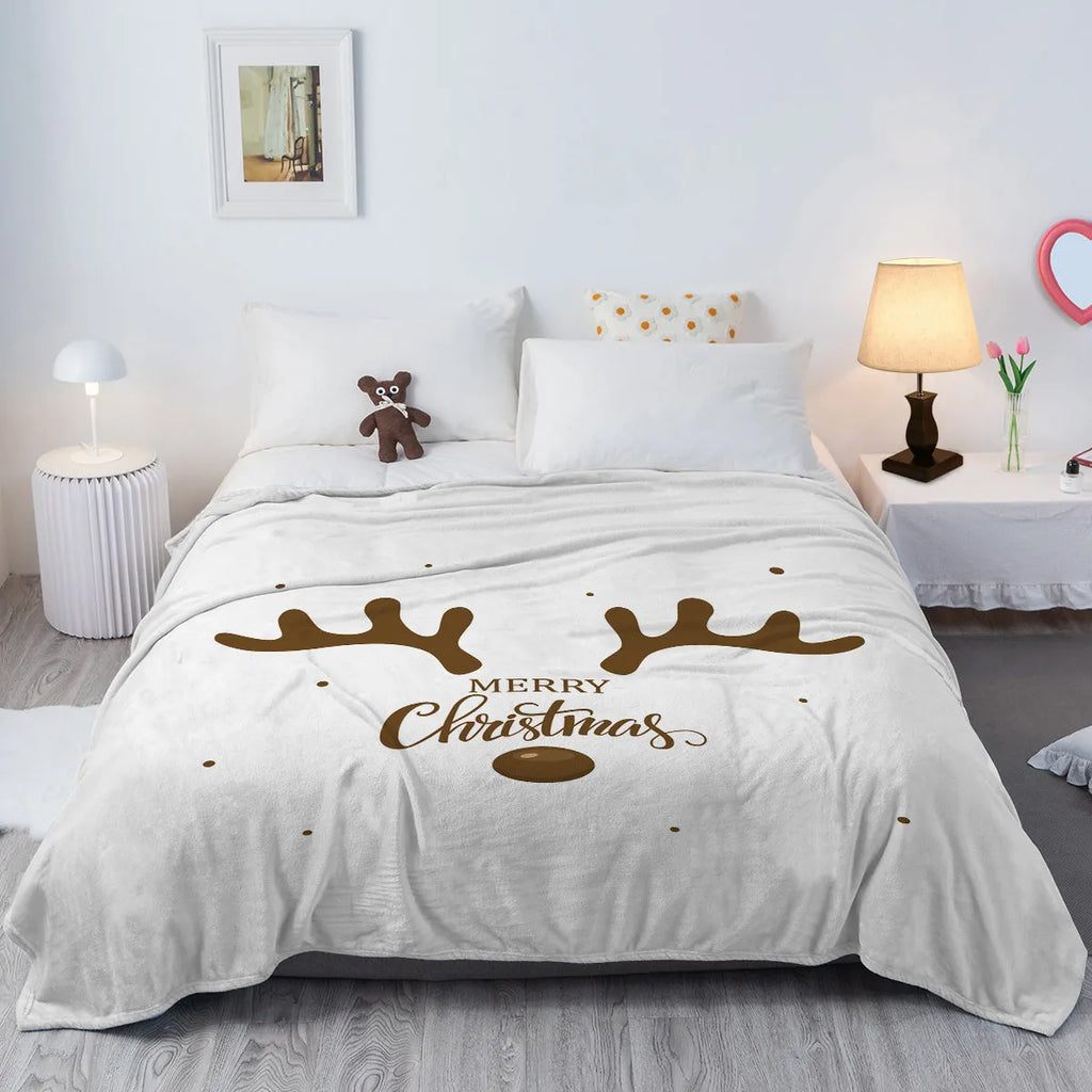 Deer antler pattern Christmas limited edition white flannel velvet blanket on a sofa