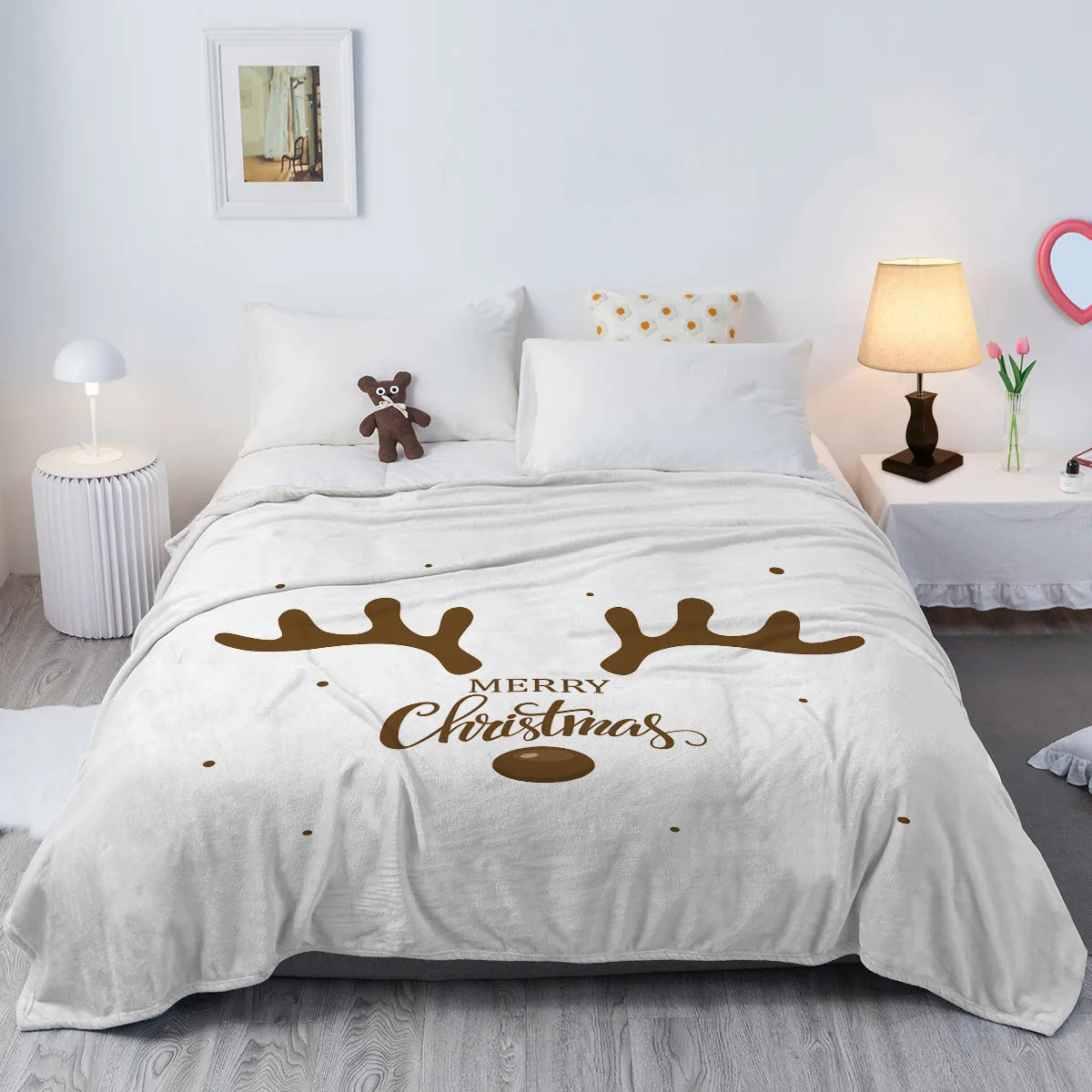 Deer antler pattern Christmas limited edition white flannel velvet blanket on a sofa