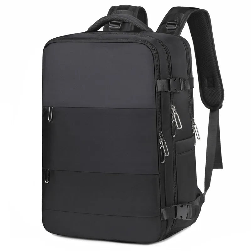 Large grey travel backpack with multiple compartments and an air pillow strap, shown next to a laptop.