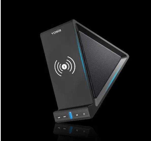 Black multifunctional Bluetooth speaker with integrated phone stand and wireless charging pad on a desk.