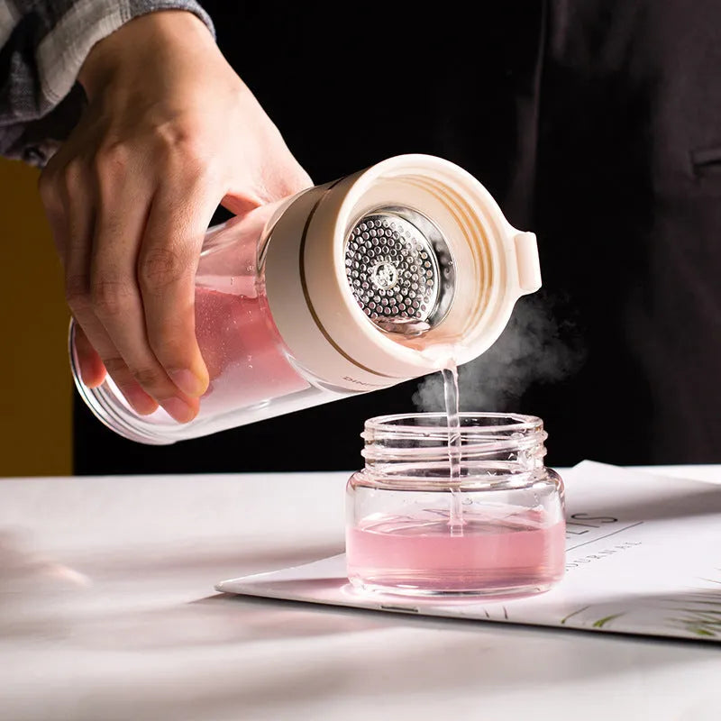 Double-wall glass water bottle with tea infuser insert and rope handle in assorted colours.