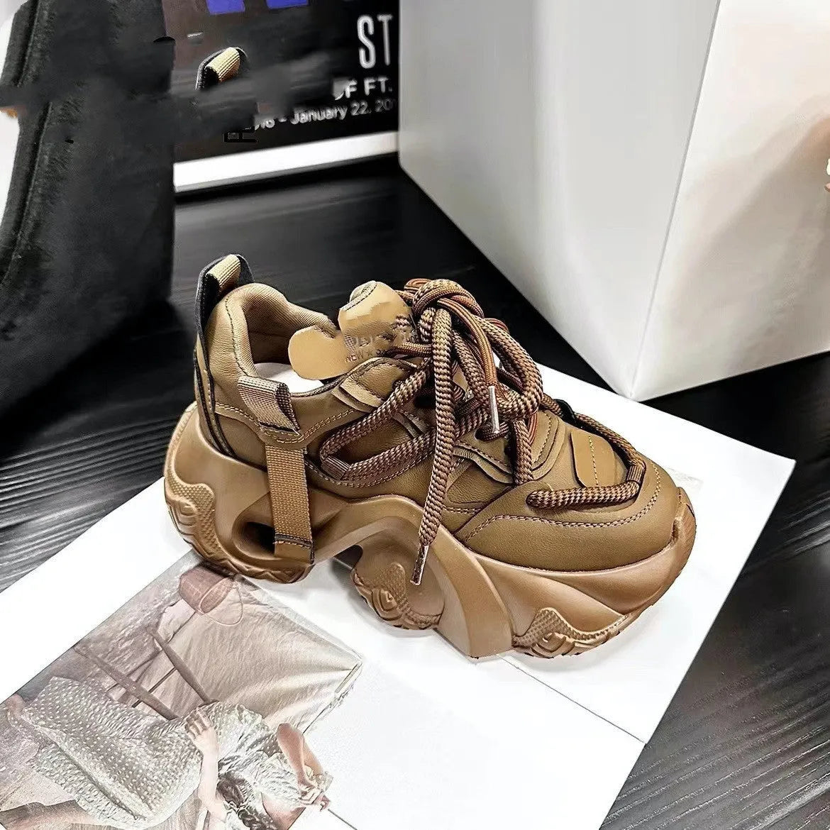 Women's creamy white platform sneakers with a thick wedge sole, lace-up front, and cross-strap detail.