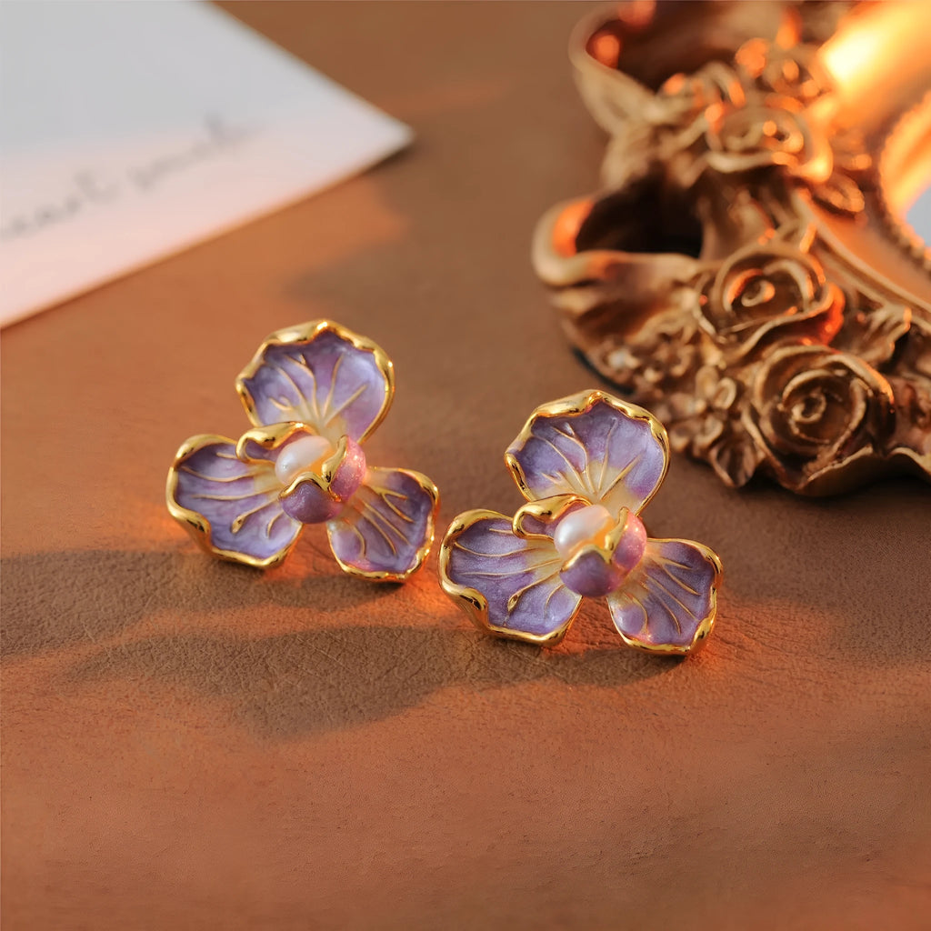 Purple copper alloy flower-shaped women's earrings with dripping oil finish on a plain background