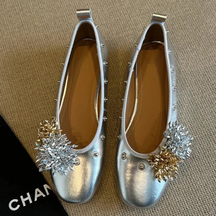 Silver Mary Jane buckle flats with DIY flower rivets on the strap, showing round toe and low top profile.