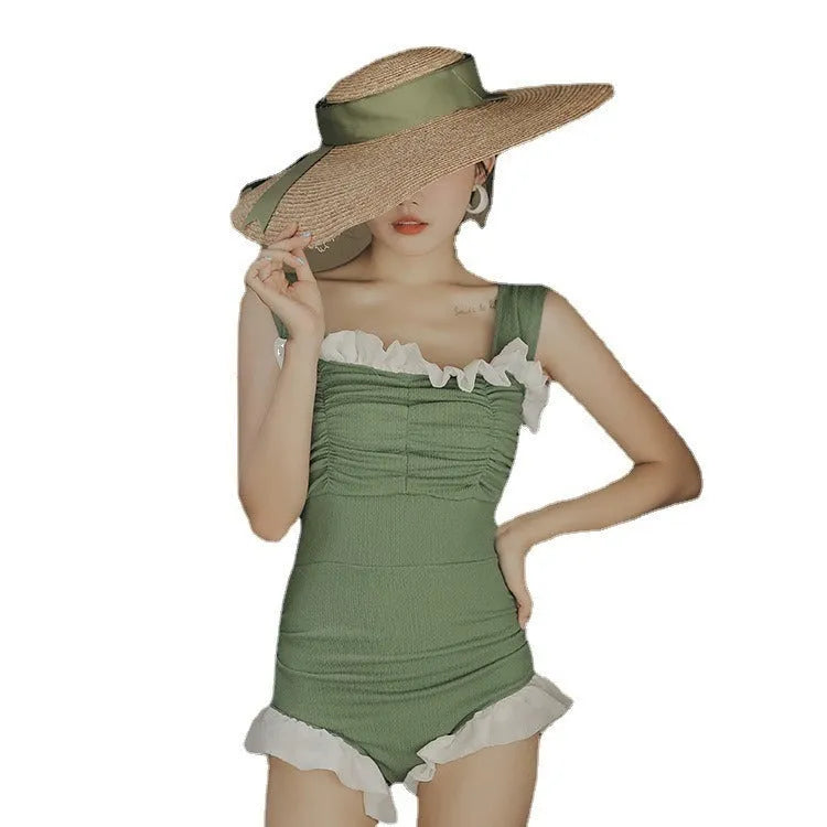 Black high-waisted one-piece swimsuit with triangle design on mannequin