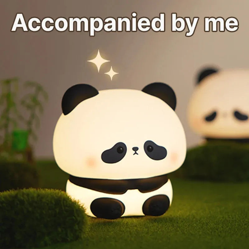 Cute panda LED night light with soft silicone cover, USB rechargeable, featuring colourful lighting modes on a bedside table.