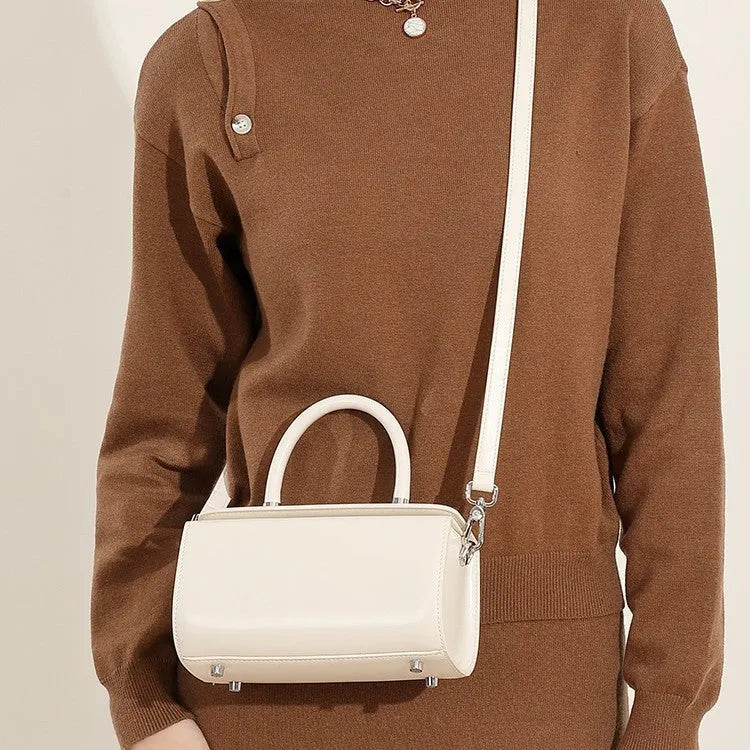 Women's leather crossbody bag in clamshell design with internal phone and document organisers