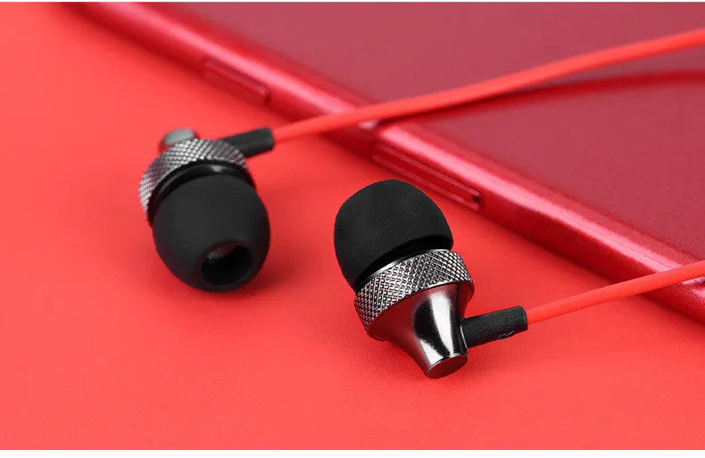 Gold metal in-ear headphones with a black wheat cable and 3.5mm plug on a white background.