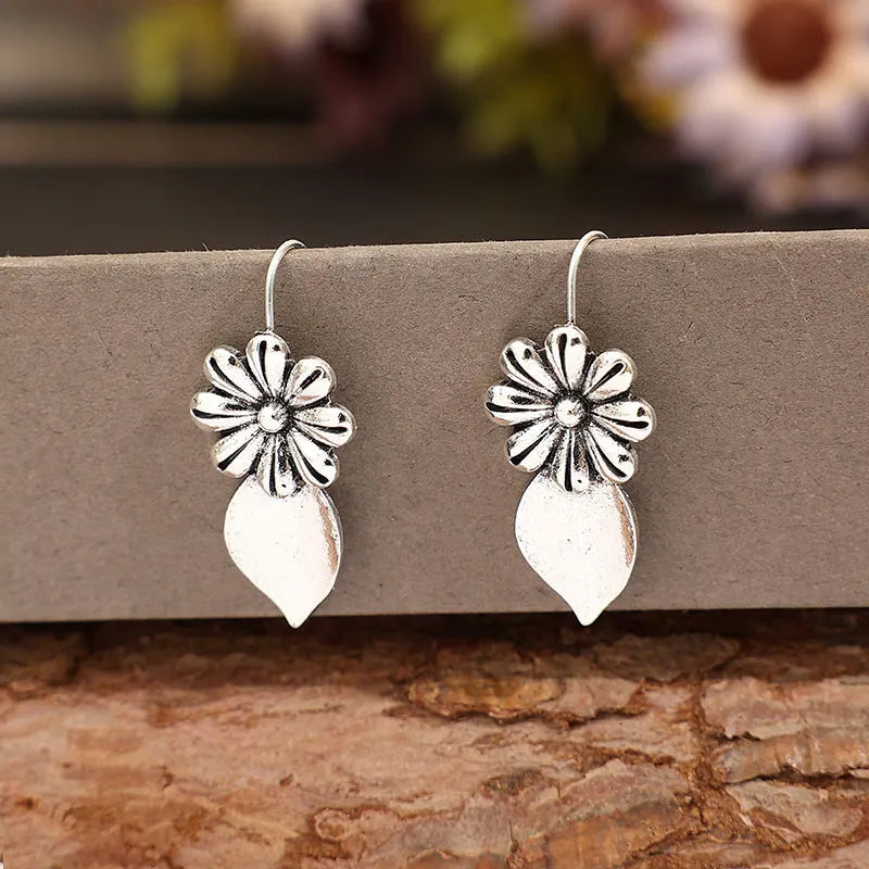 Silver alloy clip-on earrings with artificial gemstone inlays, vintage floral style, sold as a pair