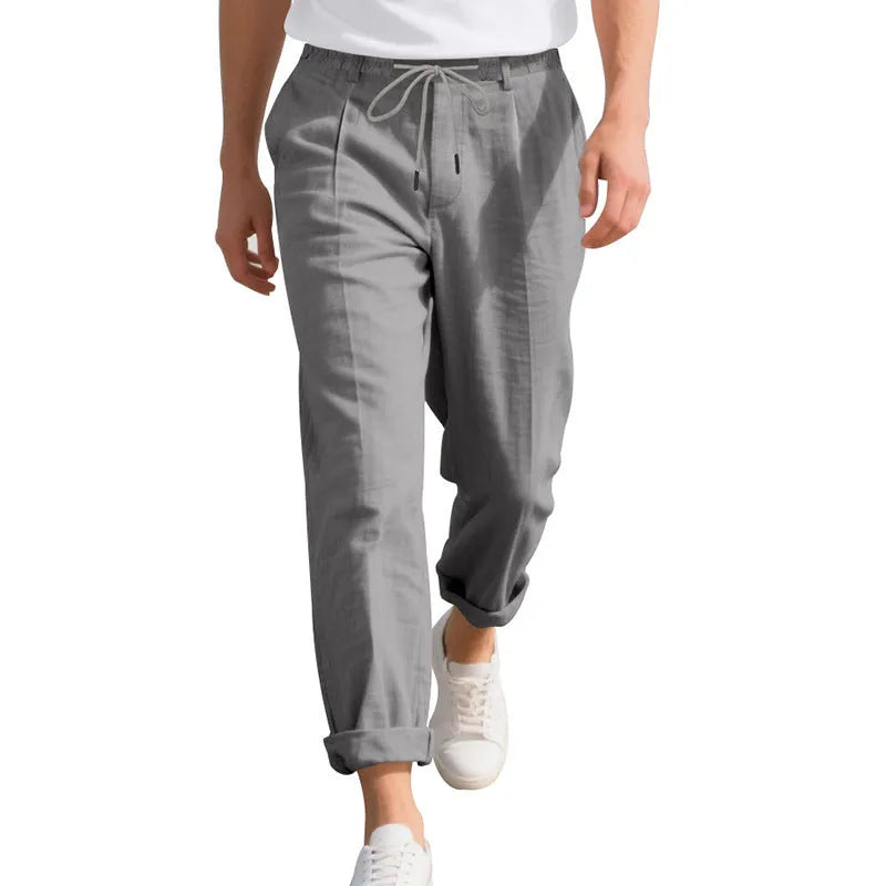 Men's light khaki linen casual trousers with drawstring waist on a hanger.