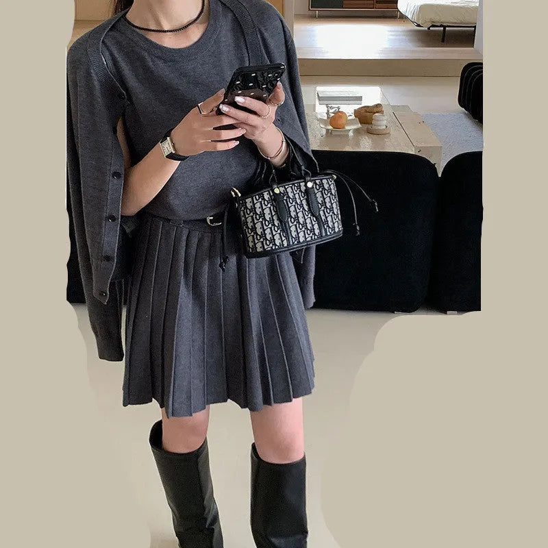 Women's grey art retro knitted two-piece set with pleated vest skirt, belt, and long sleeve cardigan featuring a 3D pattern.