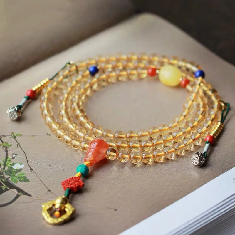 Close-up of a yellow natural citrine bracelet with 1mm beads on a filament string.