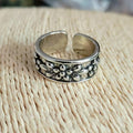 Vintage antique silver gold flower open ring with camellia design on a plain background