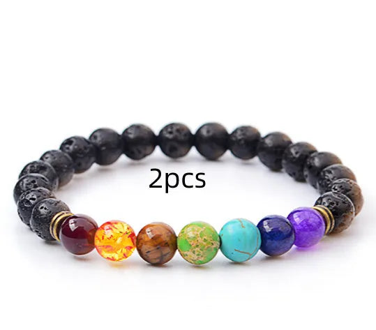 Handmade black lava seven chakra beaded bracelet on neutral background, 8mm or 10mm beads