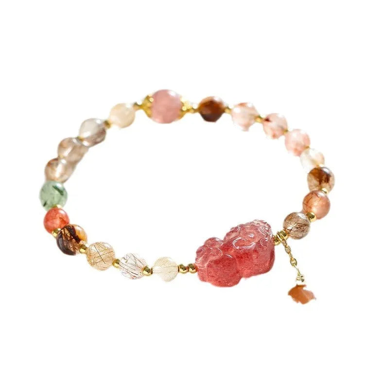 Natural strawberry quartz and copper bracelet with pearl accents on a wrist.