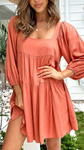 Orange and light blue children's backless dress with a square collar and puff sleeves.