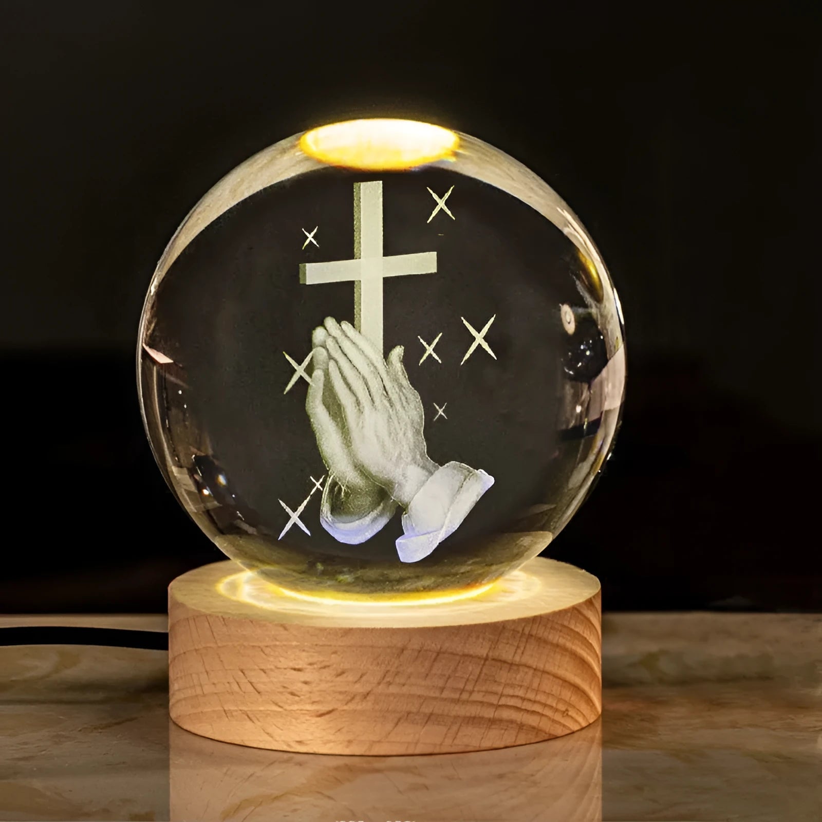 White crystal ball desk lamp with warm light on a solid wood base.
