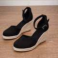 Women's apricot and black canvas wedge sandals with suede detail and a buckle fastening.