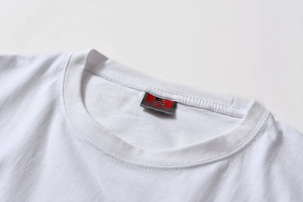 White cotton pullover overalls with short sleeves and a round neck, shown on a hanger.