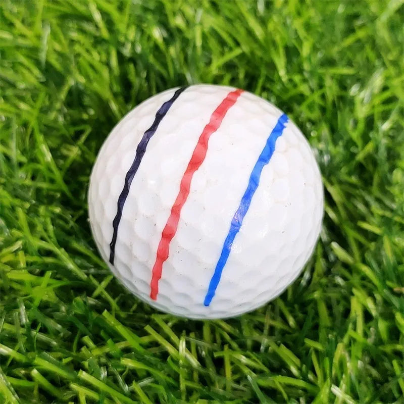 Plastic golf putting alignment tool with scriber bases and blue drawing pens on a practice putting mat.