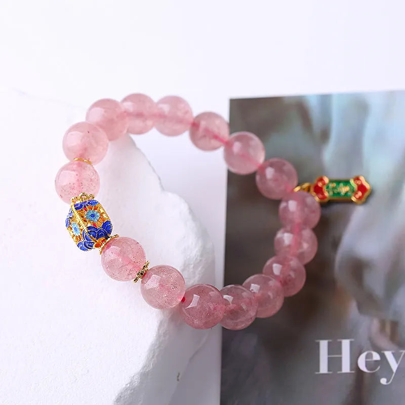 Pink strawberry quartz crystal bracelet with hand-woven Ruyi symbols and text elements