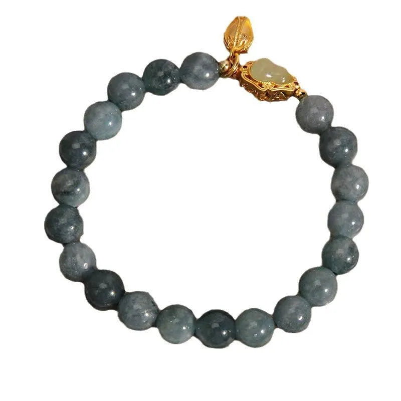 Sky blue natural stone gourd lotus pendant on a women's electroplated bracelet.