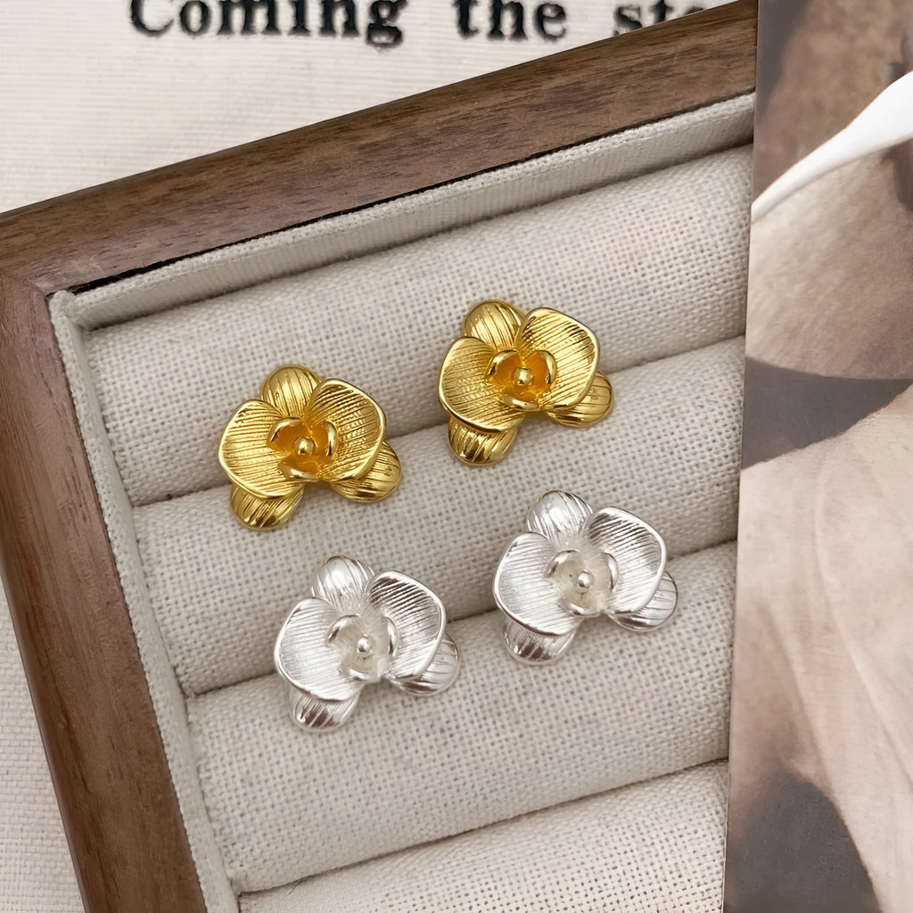 Women's retro flower earrings in copper with gold or silver electroplated finish showing petal detailing