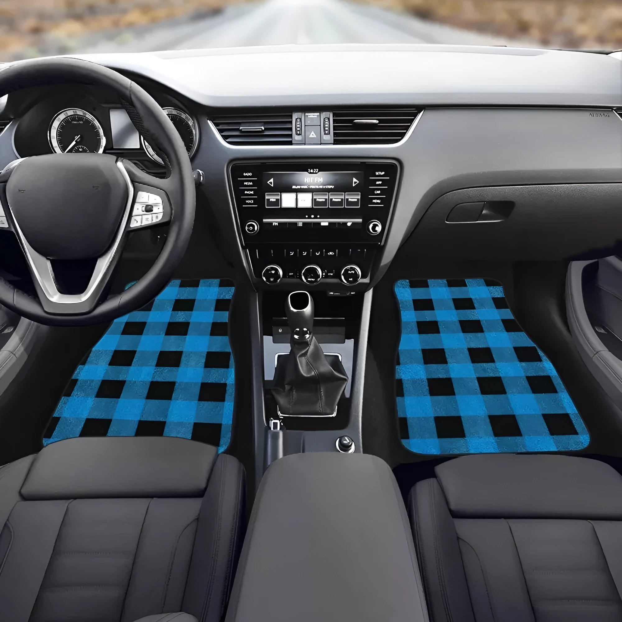 Black universal fit rubber car floor mats set of four with textured surface, shown in a vehicle footwell.