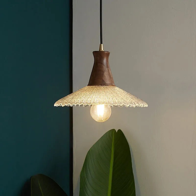 Brass and glass wooden chandelier ceiling light with clear shades in three available sizes.