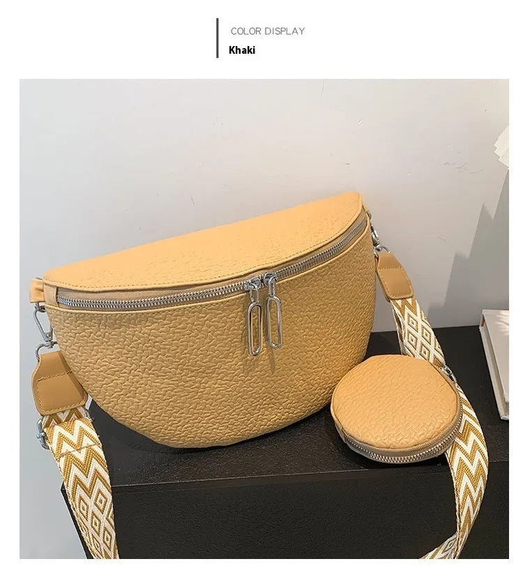 Women's solid colour PU crossbody bag with clamshell design and single shoulder strap.
