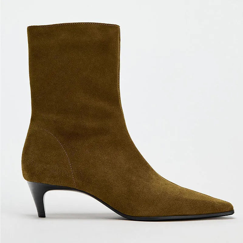 Brown square toe kitten heel mid-calf boots with side zipper on a wooden floor.