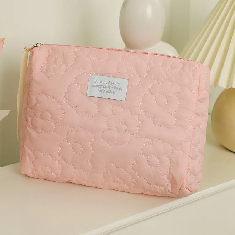 Silk quilted cosmetic bag in candy colours showing quilted texture and storage capacity