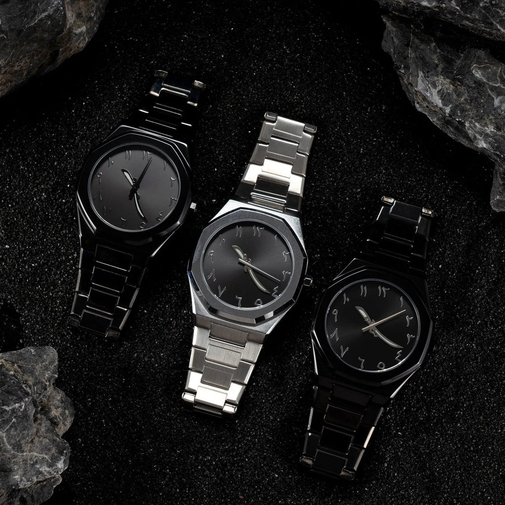 Men's business casual watch with steel bracelet showing black dial and silver scales