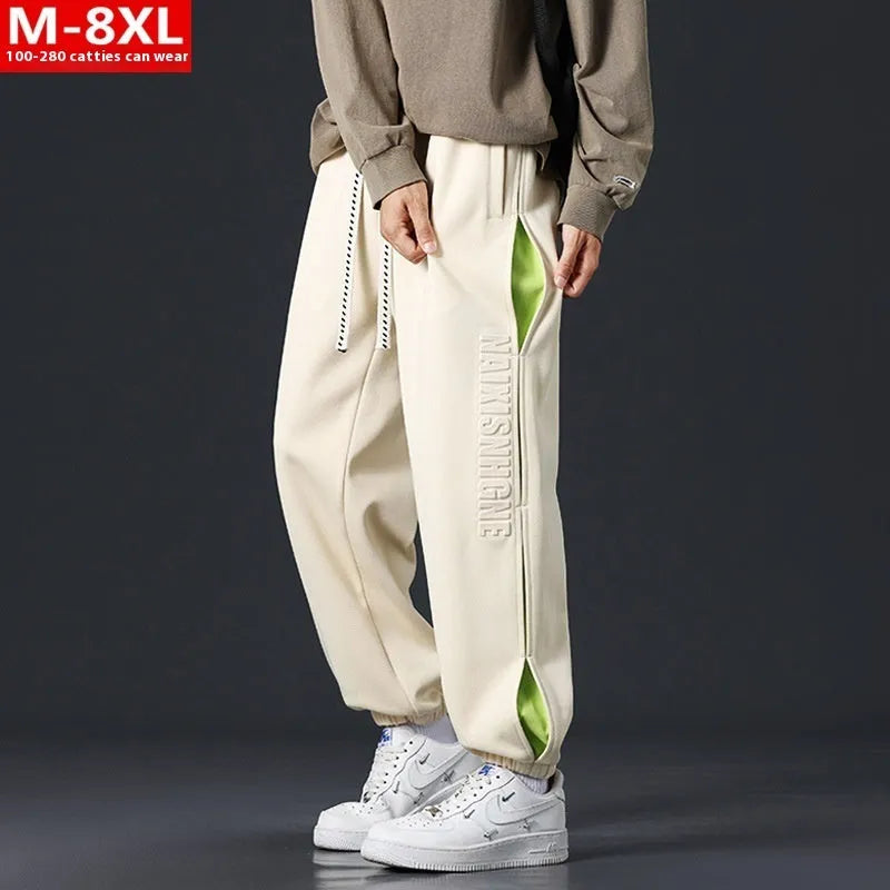 Men's loose fit cotton trousers with stitching detail and a banded ankle cuff.