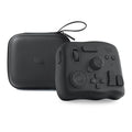 TourBox NEO black auxiliary keyboard controller for video editing on a desk.