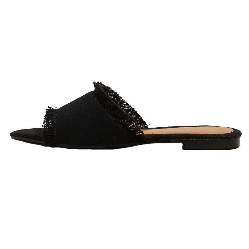 Women's denim flat slippers with tassel trim and leather lining in assorted colours.