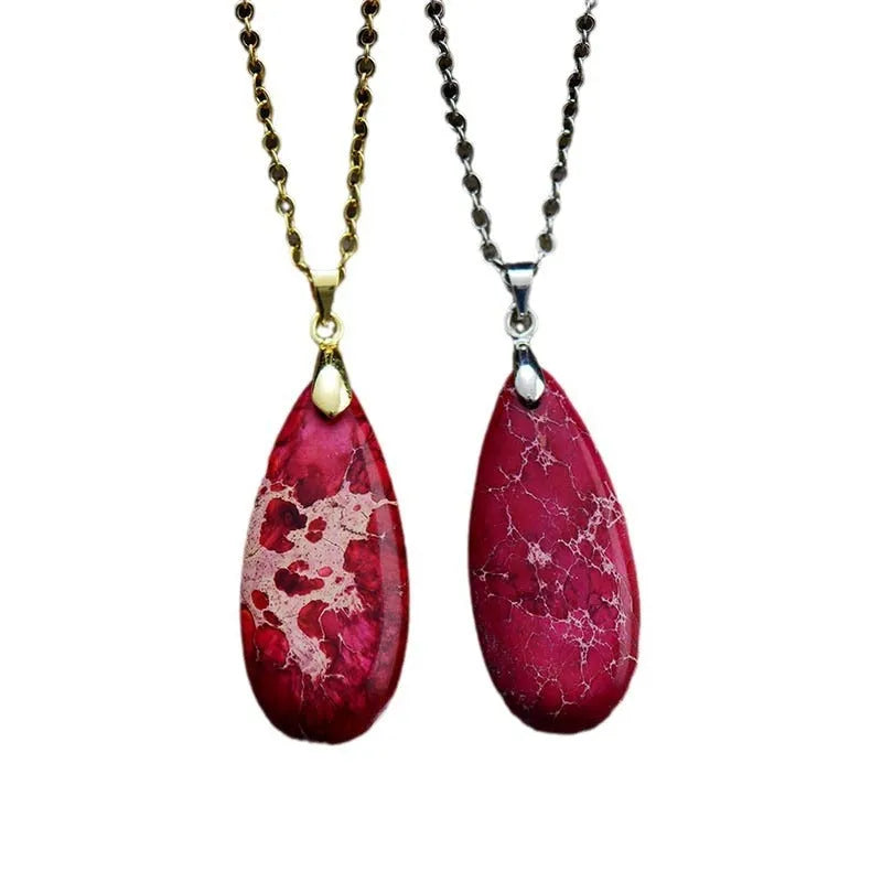 Emperor Stone jade pendant necklace on a gold chain, showing hand-carved detail and a lobster clasp.