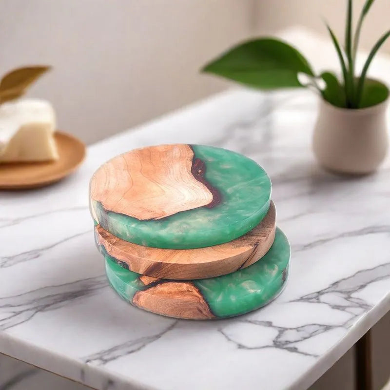 Set of solid wood coasters for tea, showing round green and black versions on a wooden table.