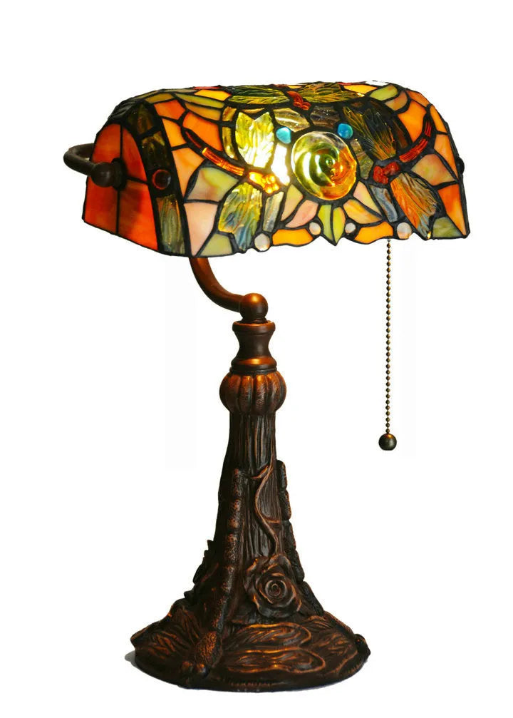 Tiffany-style desk lamp with a coloured stained glass shade on a resin base.