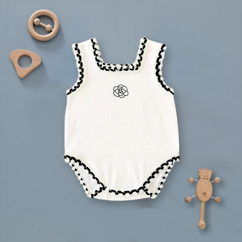 Baby triangle rompers made of cotton, sleeveless with lace accent, available in white and black, sizes for heights 59-90cm.