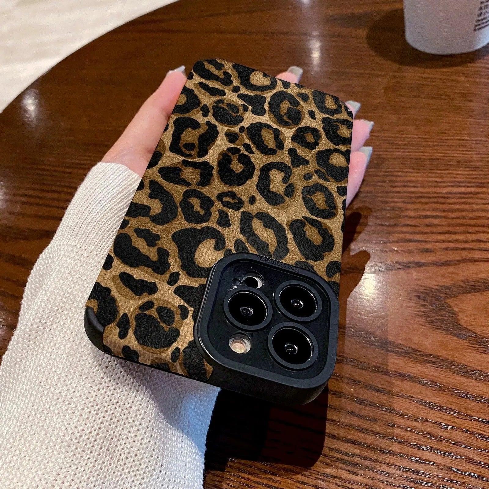 Gold leopard print all-inclusive imitation leather phone case for iPhone on a white background