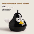 Green ceramic pear-shaped tissue box holder on wooden desk