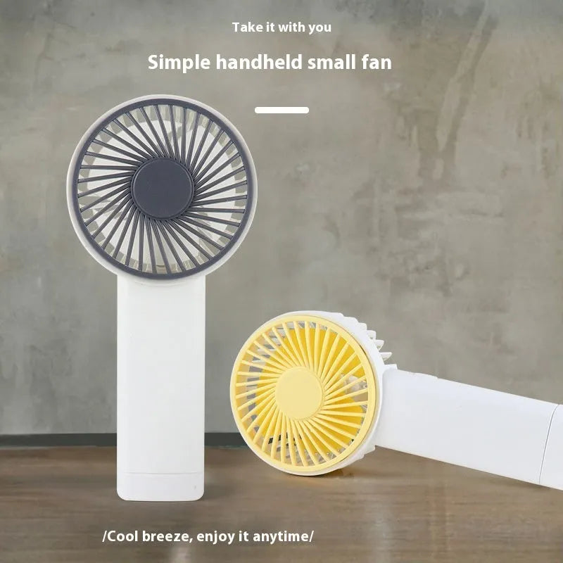 Outdoor portable USB rechargeable handheld fan in pink with plastic blades and brushed motor