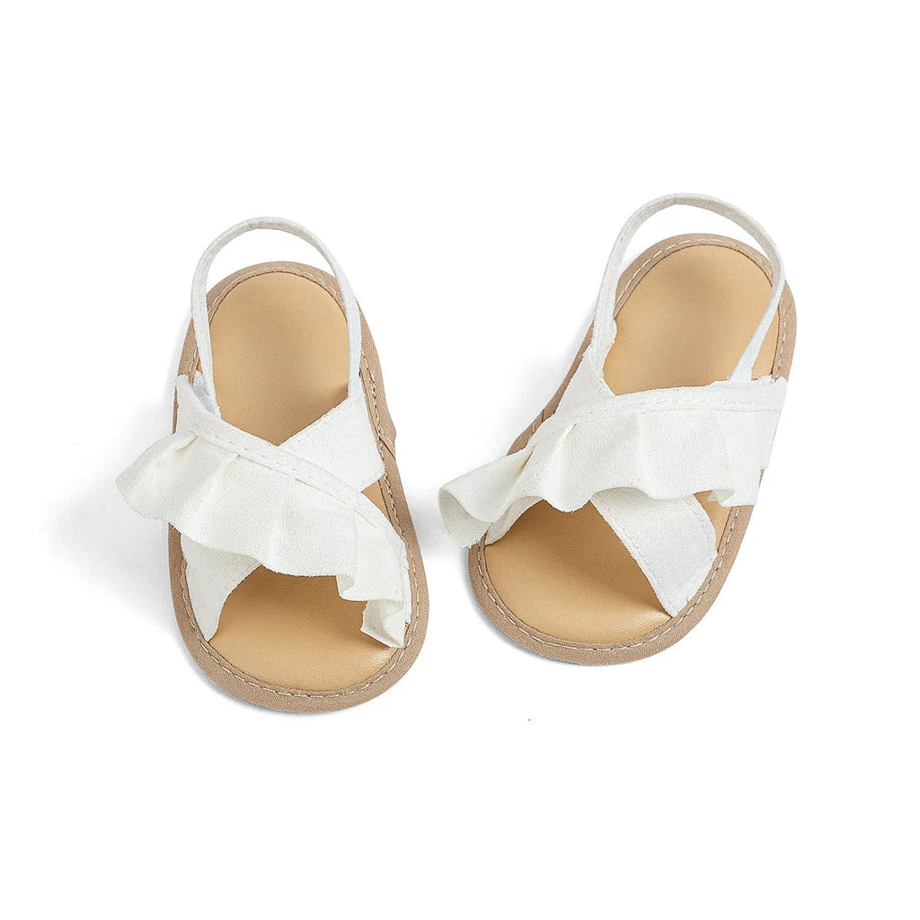 Baby girl toddler shoes with soft bottom, lace, and Velcro closure in white cotton cloth, side view