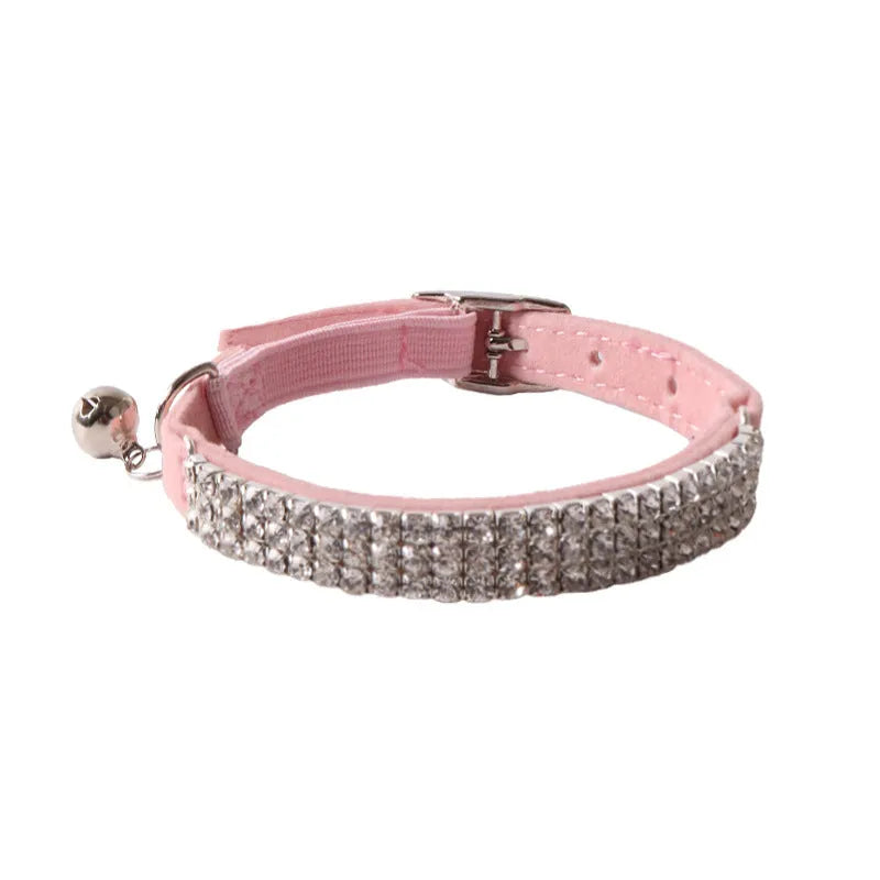 Soft pink flocked cat collar with a plastic buckle on a 28cm elastic band, showing gang drill holes for tags.